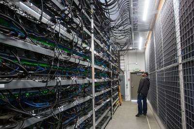 A sprawling mining farm with racks of mining rigs in operation
