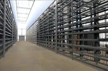 A large mining farm with rows of mining rigs.